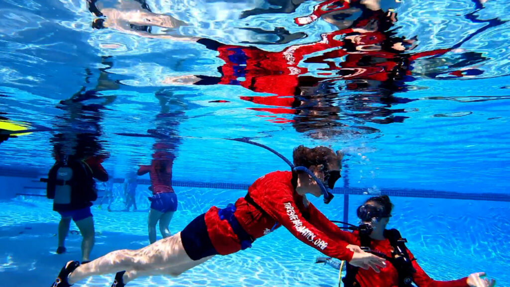 Pool operator instructing a diver using the BLU3 system.