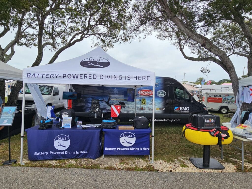 BLU3 booth at the 2025 Gigantic Nautical Market showcasing battery-powered diving systems, including the BLU3 Nomad, Nomad Mini, and Brownie’s Sealion dive system.
