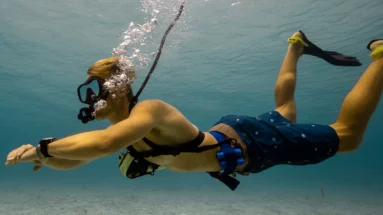 Diver exploring underwater marine life from boat using tankless dive system
