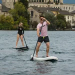 Two friends paddleboarding on inflatable SUP using an electric paddle board fin motor JAYKAY e-fin.