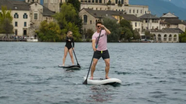 Two friends paddleboarding on inflatable SUP using an electric paddle board fin motor JAYKAY e-fin.